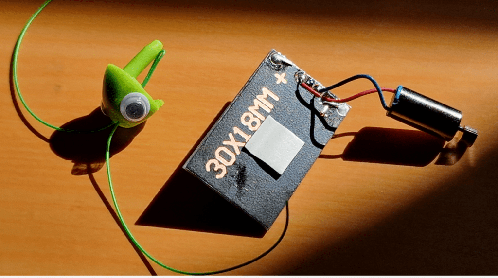 Beheaded grasshopper complete with solar panel and motor/vibrator